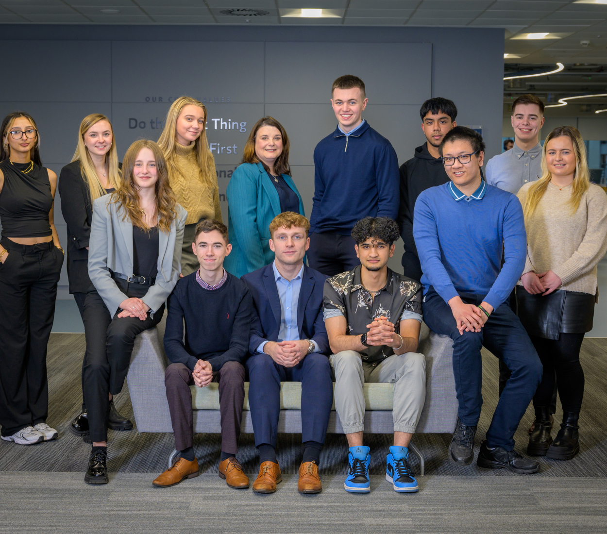 A group of Morgan Stanley apprentices smiling at a camera.